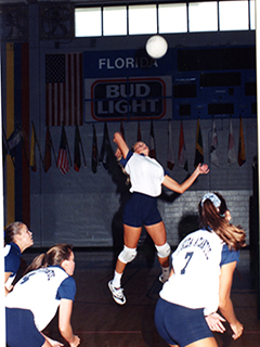 Photograph of players from the FAU volleyball team during a game