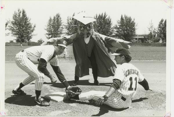 An old Owlsley mascot standing with students