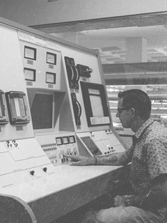 Photograph of a man working with technology