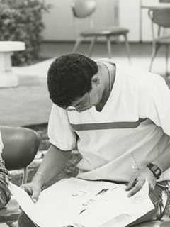 Photograph of students reading a FAU student newspaper
