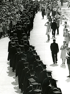 Digital scan of a group of students walking during commencement