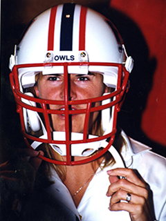 Photograph of a FAU football player wearing a FAU Football helmet