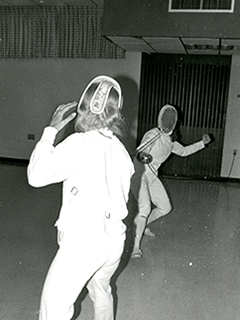 Photograph of two people fencing