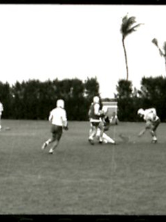 Photograph of a group of people laying lacrosse