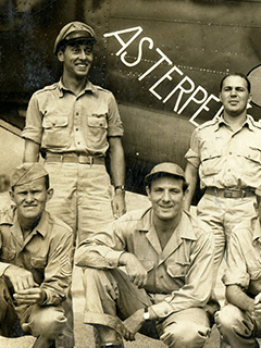 Image of men standing in front of an aircraft
